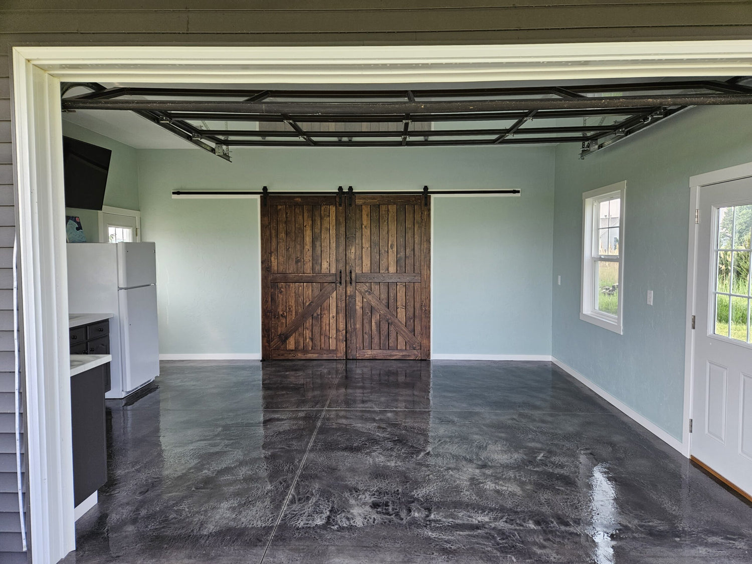 Hand-troweled garage floor stained in Charcoal Antiquing and sealed