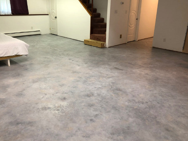 A basement concrete floor dyed in Stormy Gray, Light Slate and White