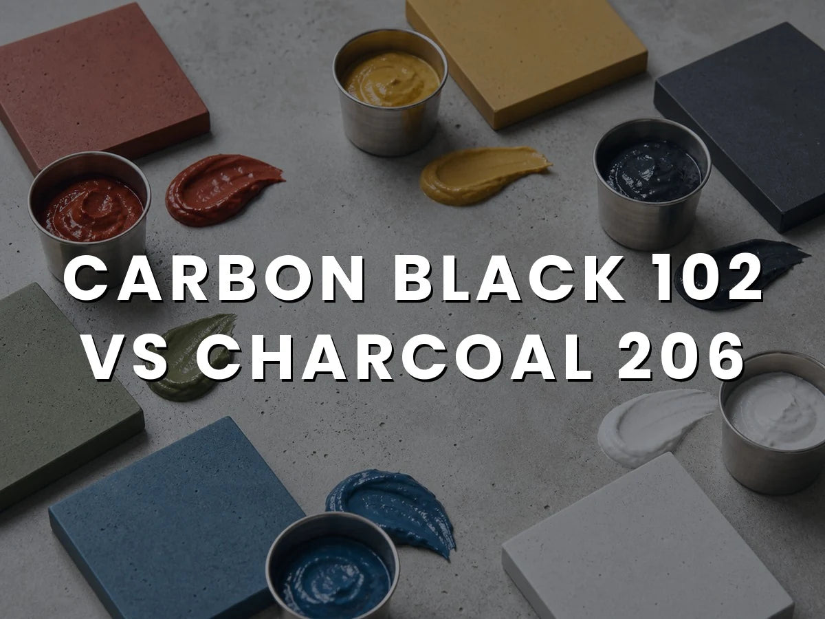 Red, yellow, black, green, blue and white liquid concrete pigment pastes in steel cups, smeared beside pavers cast in the matching colors, titled “Carbon Black 102 vs Charcoal 206”