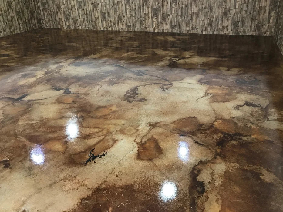 A fully stained and sealed man cave floor with a glossy, marbled finish in warm brown tones