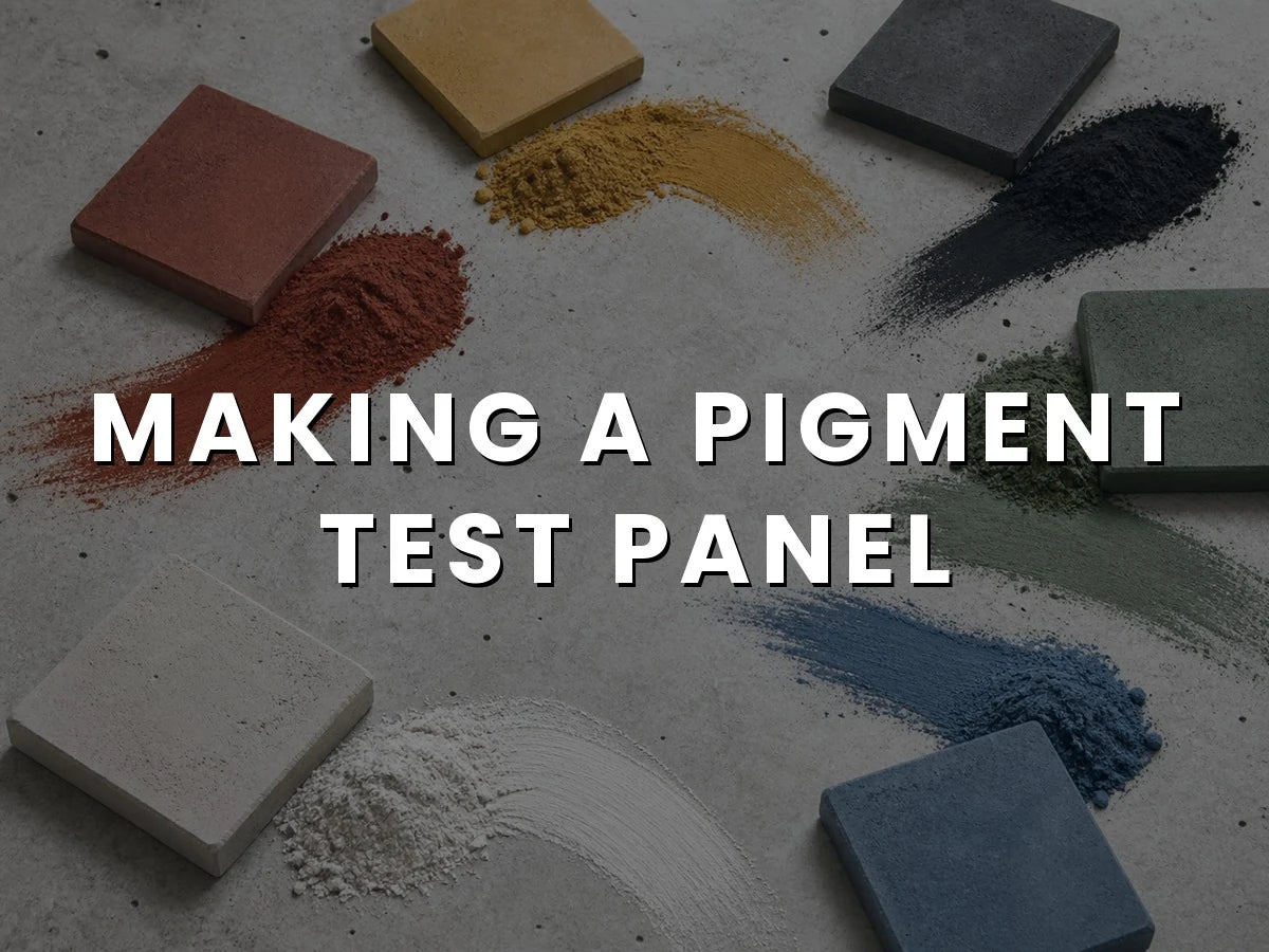 Red, yellow, black, green, white and blue concrete pigment powders swept across a concrete surface beside pavers cast in the matching colors, titled “Making a Pigment Test Panel”