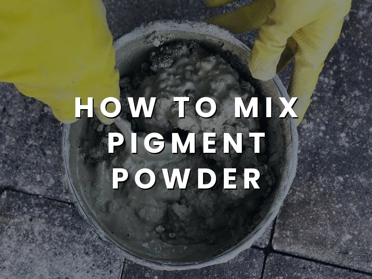 Person mixing dry cement and water in a large bucket to create a smooth concrete mixture for a DIY project