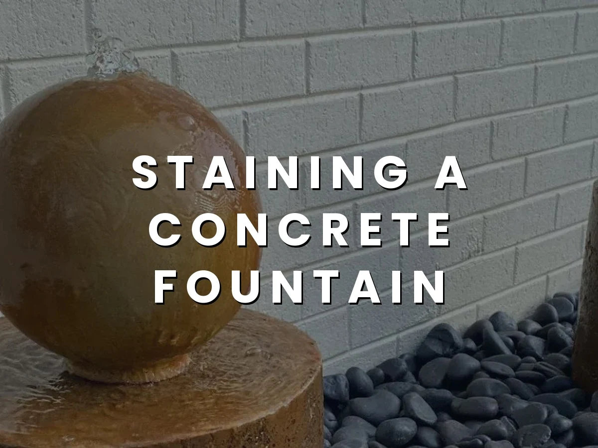 Acid stained concrete water fountain in a garden setting