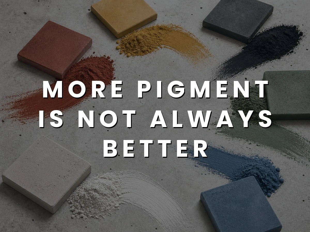 Red, yellow, black, green, white and blue concrete pigment powders swept across a concrete surface beside pavers cast in the matching colors, titled “More Pigment Is Not Better”