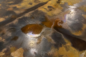 Desert Amber and Coffee Brown acid stains reacting and developing on a concrete floor