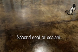 Sealed Desert Amber and Coffee Brown leather look acid-stained concrete floor with deepened color