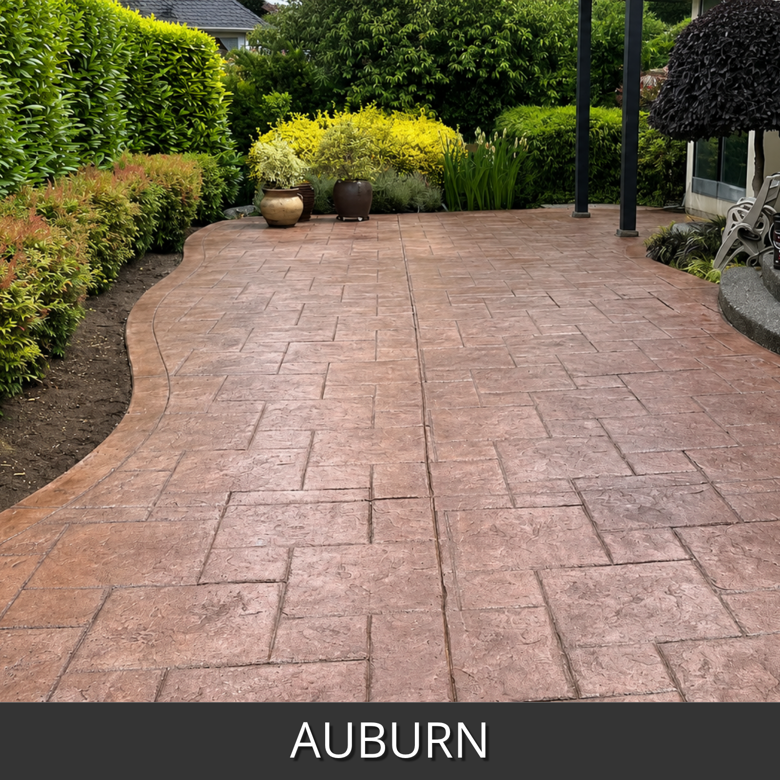 An auburn colored stamped concrete patio slab in a landscaped garden setting