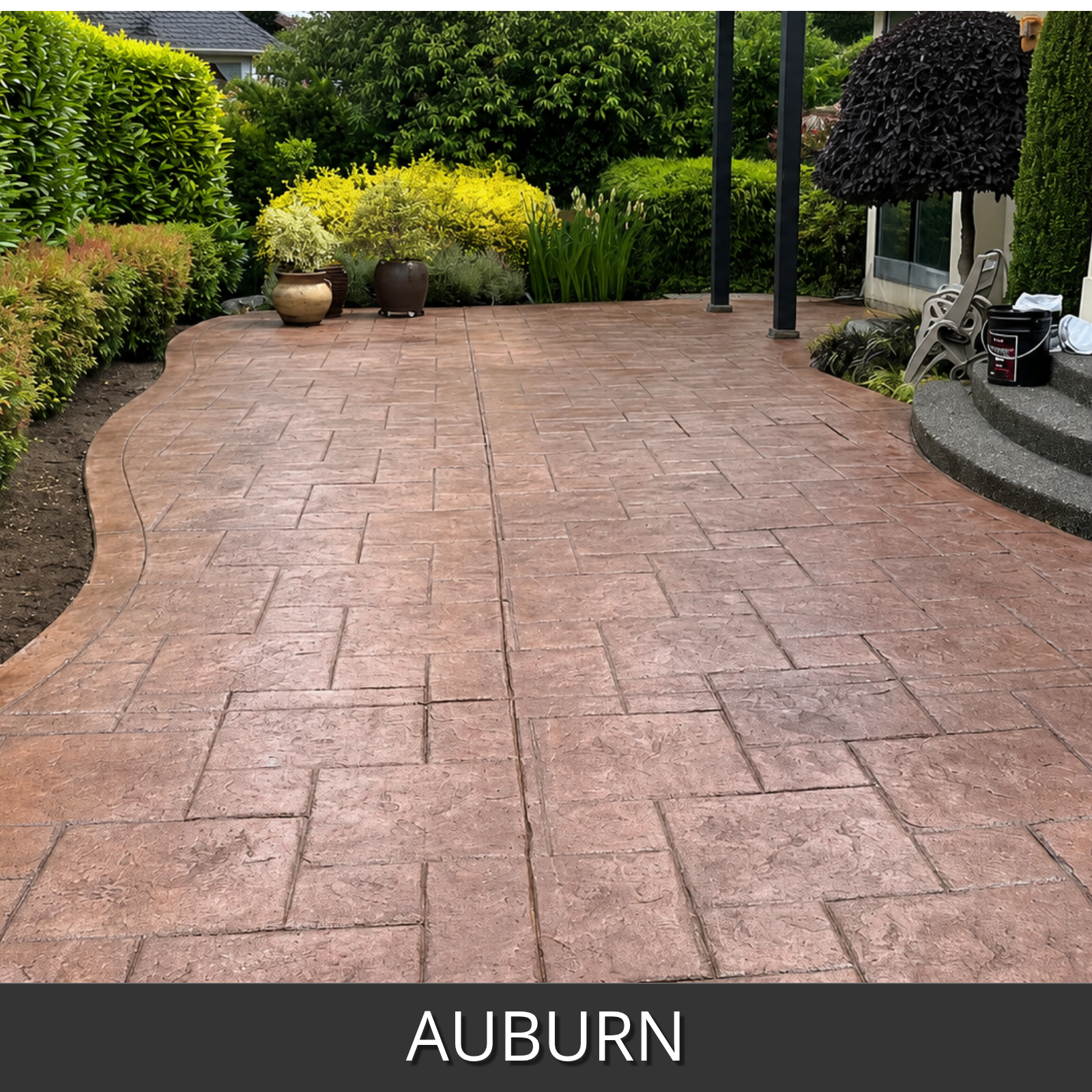 Paved patio with herringbone pattern in Auburn color, surrounded by greenery