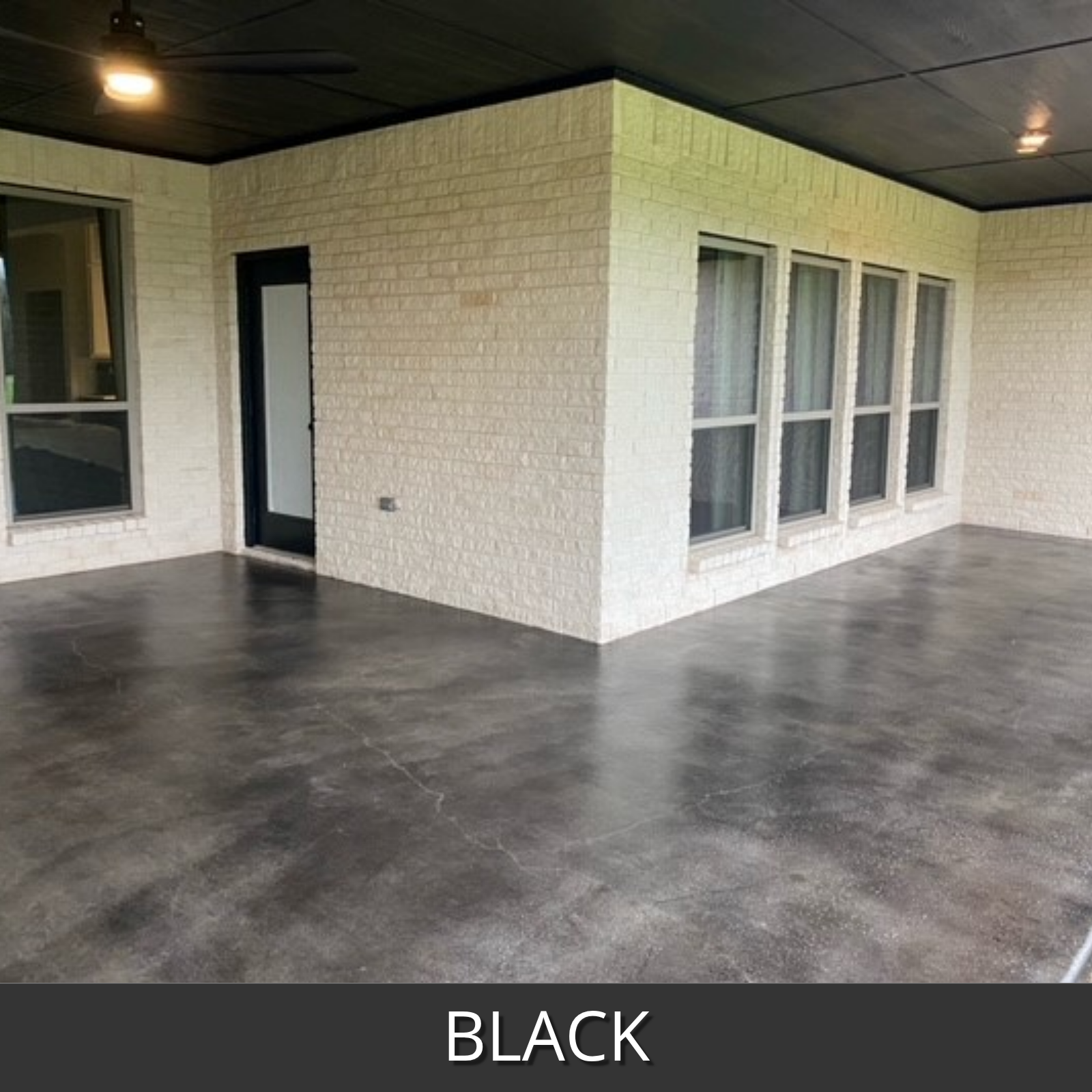 covered concrete patio floor stained with black antiquing stain and white brick walls, labeled 'Black'.