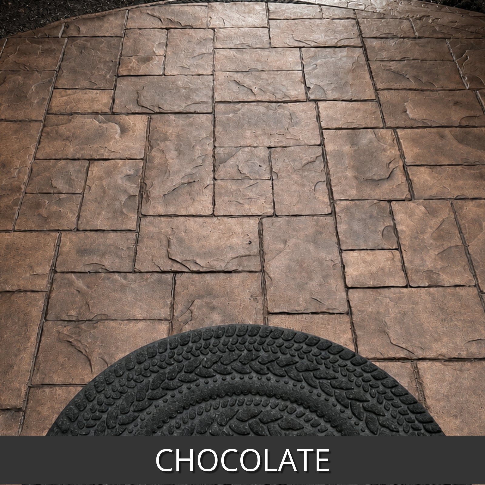 Chocolate antiquing stain colored stone paver pattern with a textured black mat at the bottom