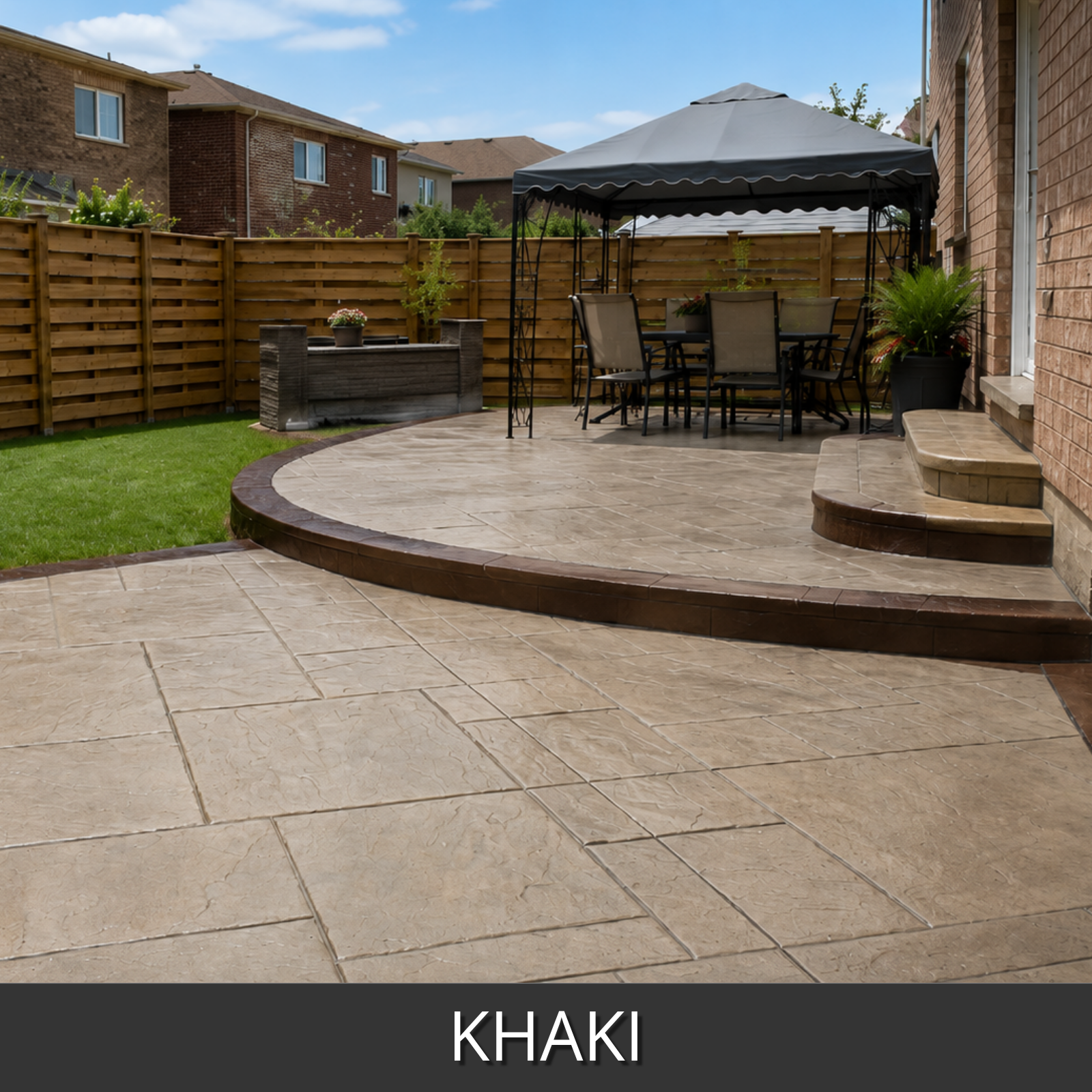 A stamped concrete patio in a backyard setting, featuring a curved raised deck and a flat main patio in a warm khaki stain color