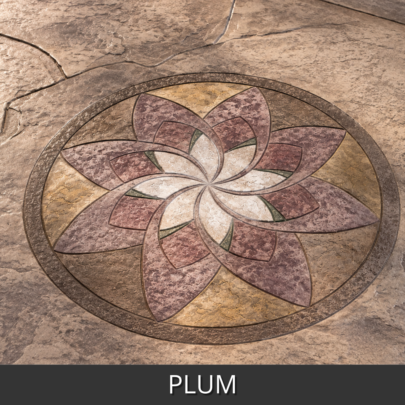 A decorative oval mosaic concrete inlay with a floral petal pattern in plum, wheat, buff, and cafe royale antiquing stains, shown on a textured concrete surface.