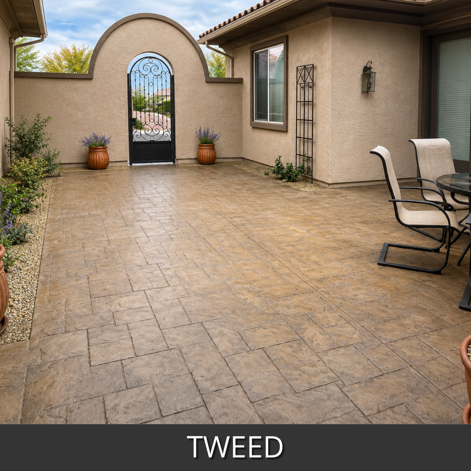 A stamped concrete patio in a backyard setting, featuring a textured 'Tweed' pattern in warm tan and brown tones