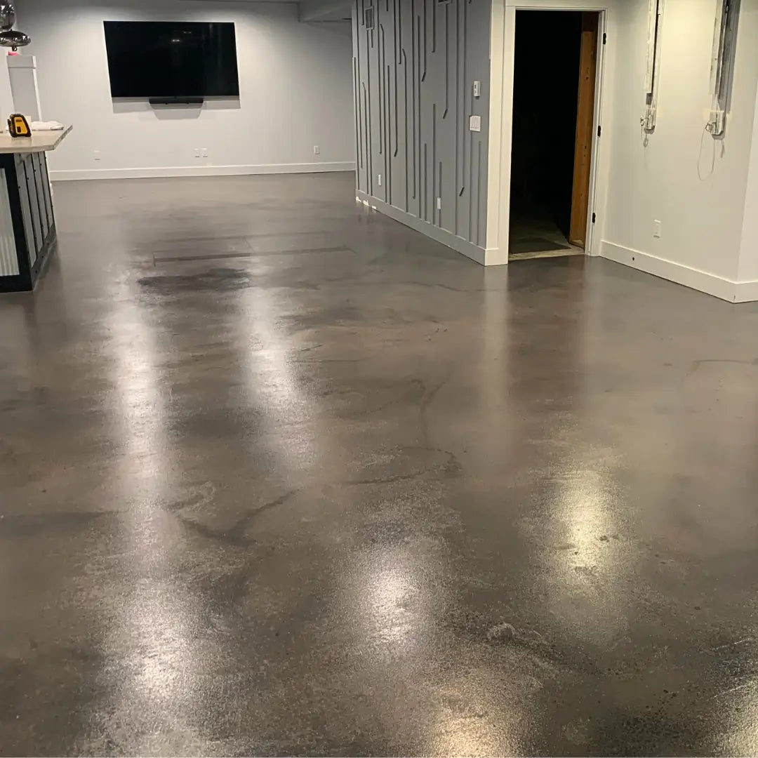 Polished concrete floor in a room with a television mounted on the wall.