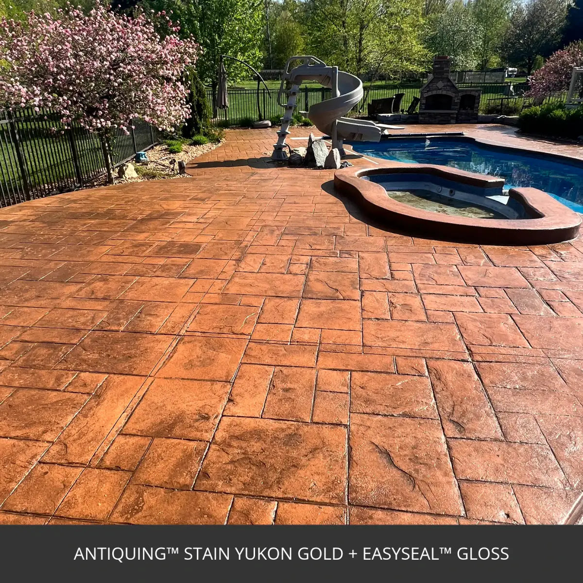 Stamped concrete pool deck with a spa in a fenced back yard, Antiquing™ Stamped Concrete Stain in 430 Yukon Gold with EasySeal™ Gloss