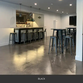 Sealed concrete floor in a basement bar area with stools, AcquaTint™ PRO Colored Sealer in 503 Black
