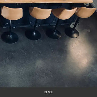 Sealed concrete floor under a bar with upholstered stools, AcquaTint™ PRO Colored Sealer in 503 Black