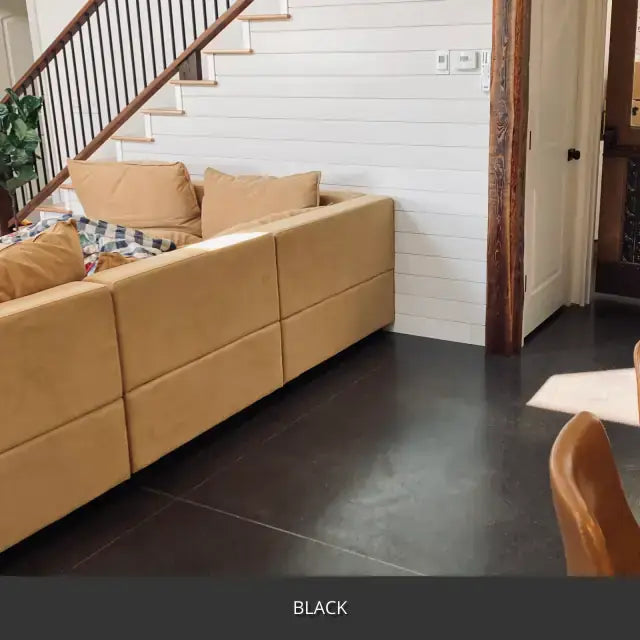Sealed concrete floor in an open plan living room with a staircase, AcquaTint™ PRO Colored Sealer in 503 Black
