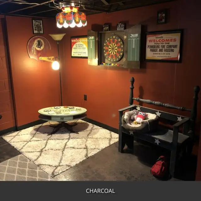 Sealed concrete floor in a basement game room with dart boards, AcquaTint™ PRO Colored Sealer in 506 Charcoal