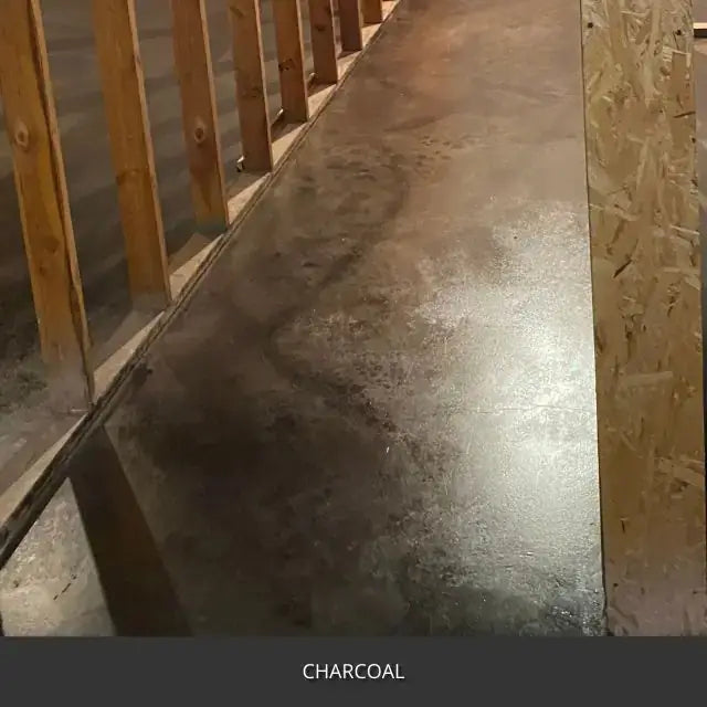 Sealed concrete floor in a barn or shop under a wood stair, AcquaTint™ PRO Colored Sealer in 506 Charcoal