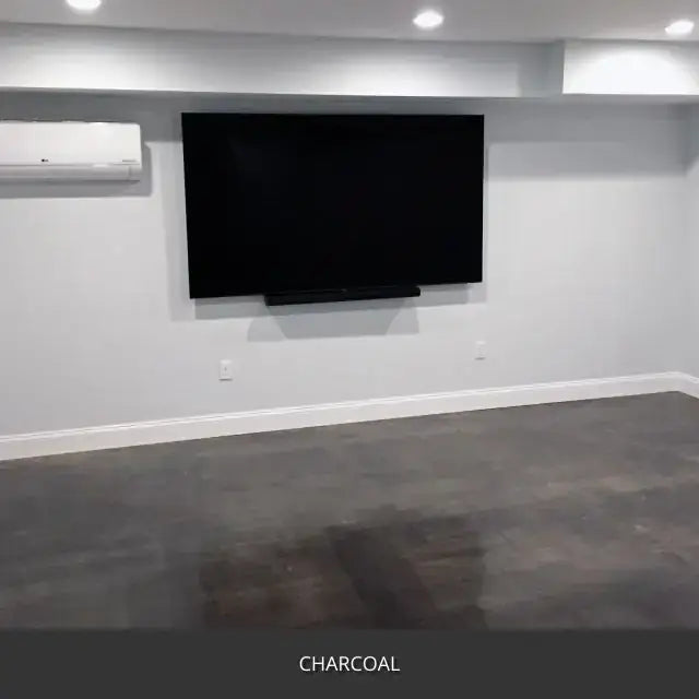 Sealed concrete floor in a basement media room with a wall mounted TV, AcquaTint™ PRO Colored Sealer in 506 Charcoal