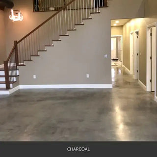 Sealed concrete floor in an entry hall with a staircase, AcquaTint™ PRO Colored Sealer in 506 Charcoal