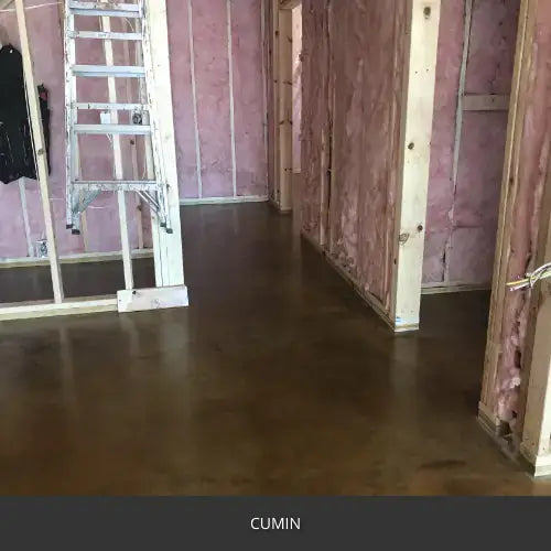 Sealed concrete floor in a room under construction with exposed framing, AcquaTint™ PRO Colored Sealer in 510 Cumin