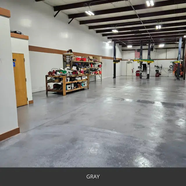 Sealed concrete floor in a workshop with steel columns and shelving, AcquaTint™ PRO Colored Sealer in 515 Gray