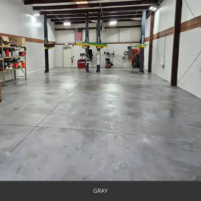 Sealed concrete floor in a shop with steel columns and equipment, AcquaTint™ PRO Colored Sealer in 515 Gray