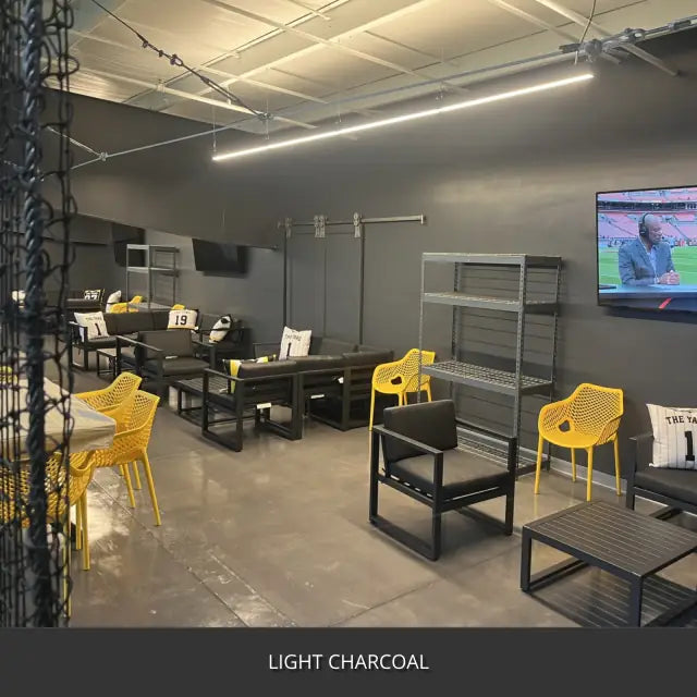 Sealed concrete floor in a training room with tables and yellow chairs, AcquaTint™ PRO Colored Sealer in 517 Light Charcoal