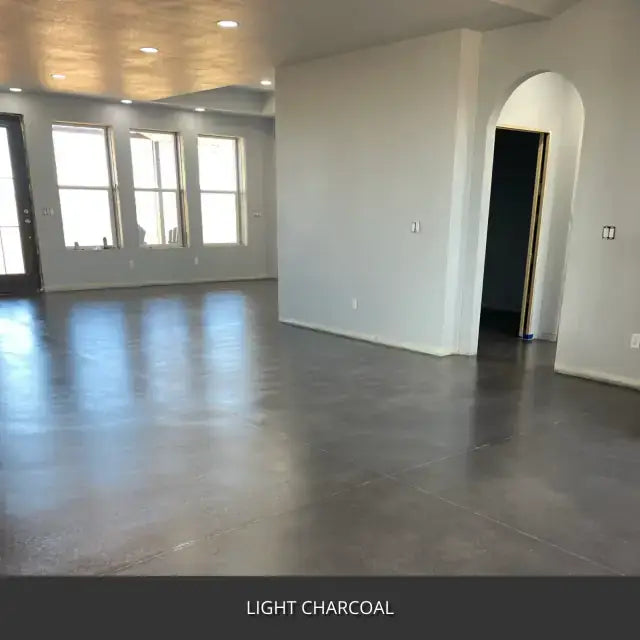 Sealed concrete floor in an empty room with an arched doorway, AcquaTint™ PRO Colored Sealer in 517 Light Charcoal