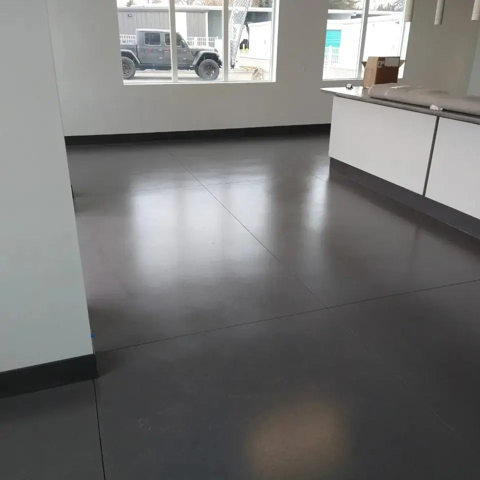 Sealed concrete floor in a retail or office space with a counter, AcquaTint™ PRO Colored Sealer in 524 Silver Gray