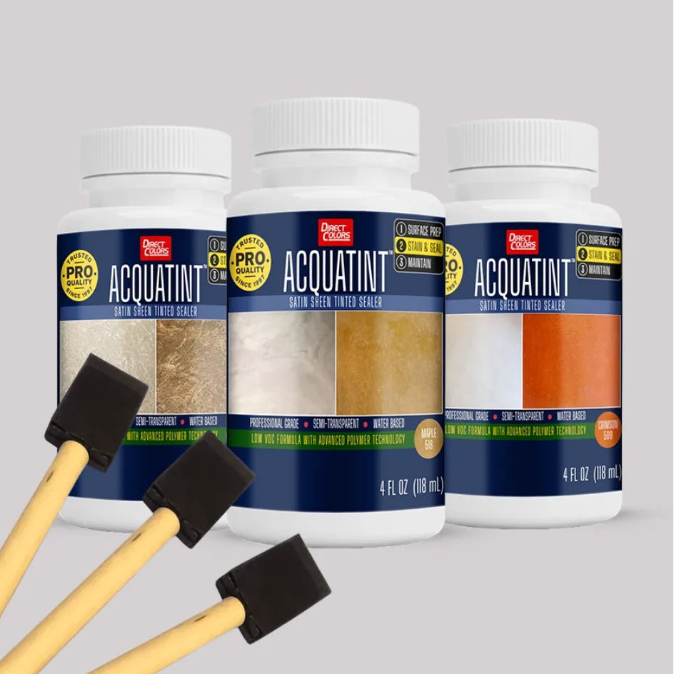 Three bottles of Acquatint paint with color swatches and two painting brushes on a gray background