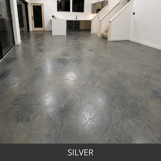 Stained concrete floor in an open living space with a staircase, ColorWave® Stain in 602 Silver