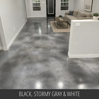 Dyed concrete floor in an open living area with a sectional, Vibrance™ Concrete Dye in Black, Stormy Gray and White
