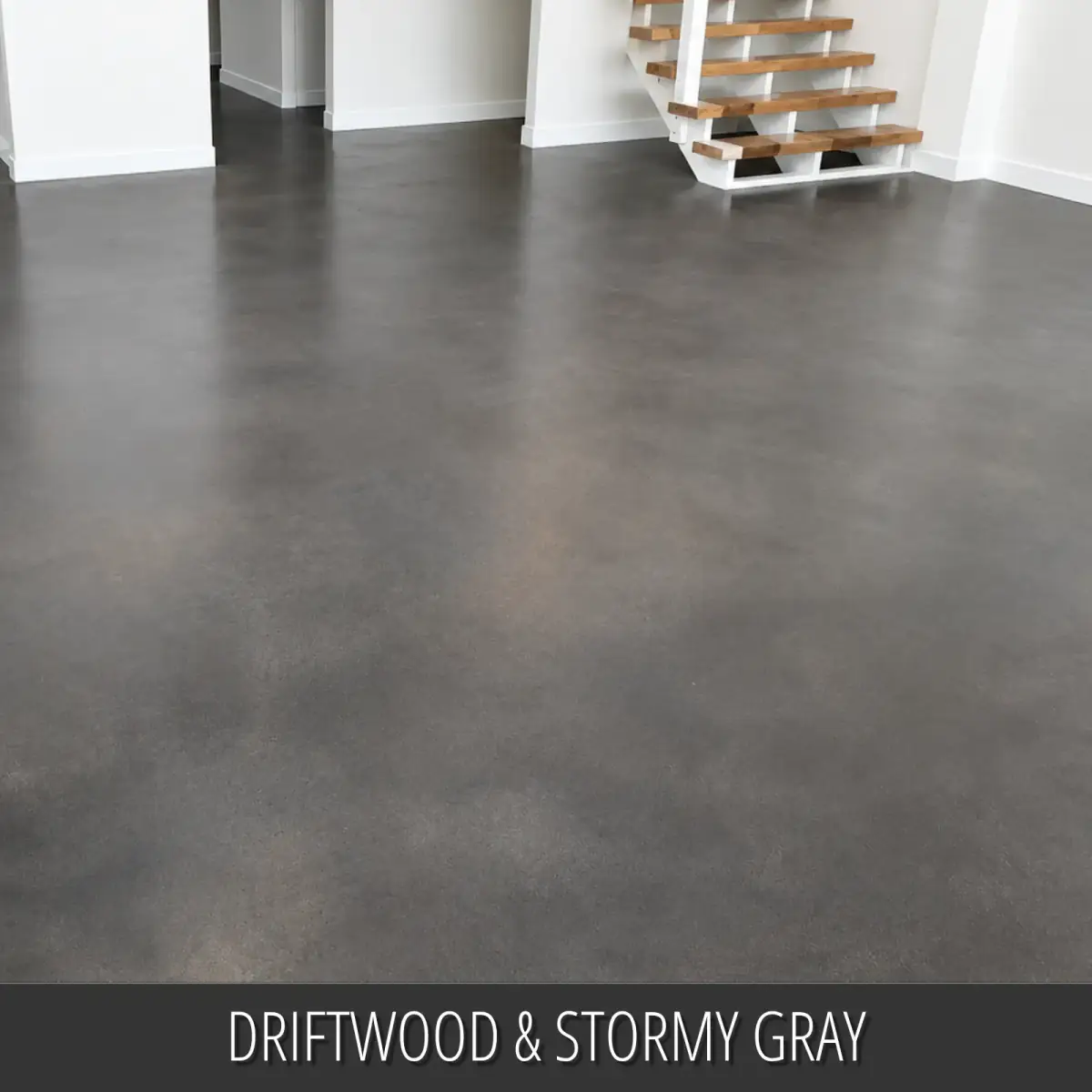 Dyed concrete floor in an open room with an open stair, Vibrance™ Concrete Dye in Driftwood and Stormy Gray