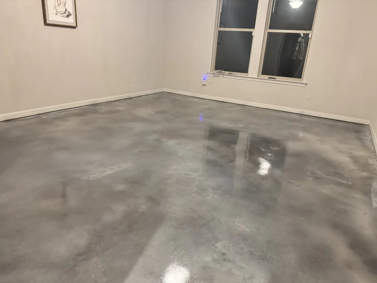 Polished concrete floor in an open living area, sealed with EasySeal™ Gloss and ProWax Polish™, Vibrance™ Concrete Dye in Buff, Stormy Gray and White