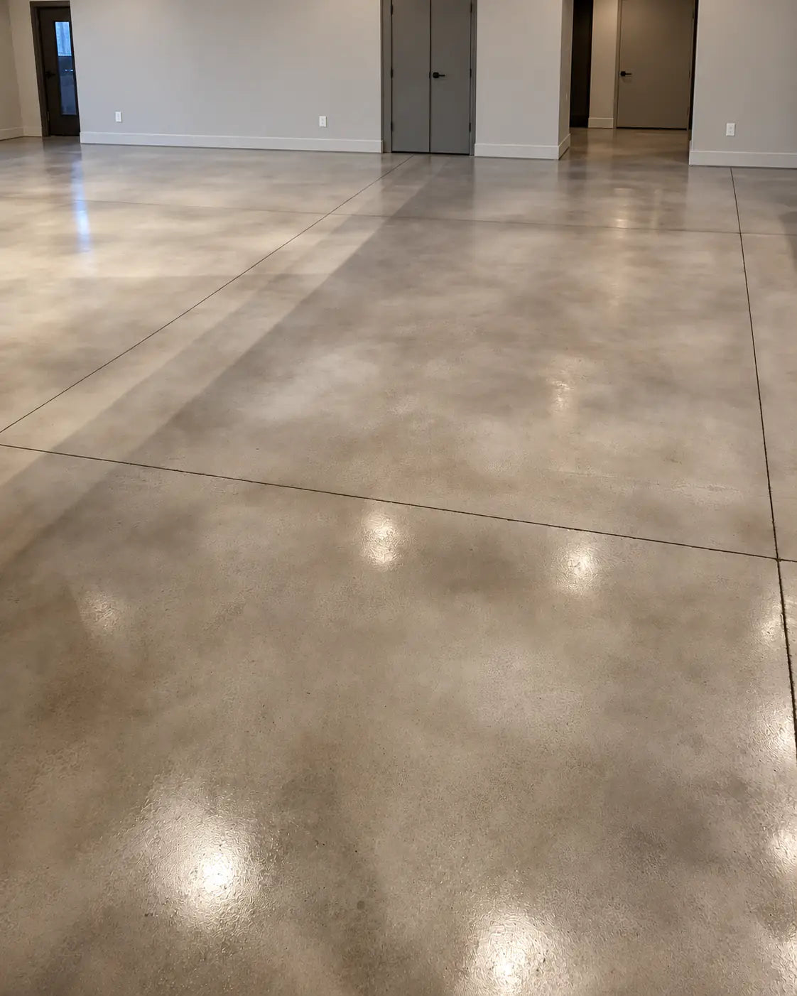 Dyed concrete floor in a residential hallway, sealed with EasySeal™ Satin, Vibrance™ Concrete Dye in Charcoal and White