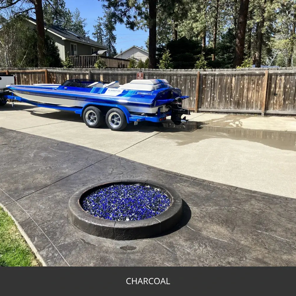 Sealed concrete patio with a gas fire pit and a boat on a trailer, EasyTint™ Tinted Concrete Sealer in 506 Charcoal