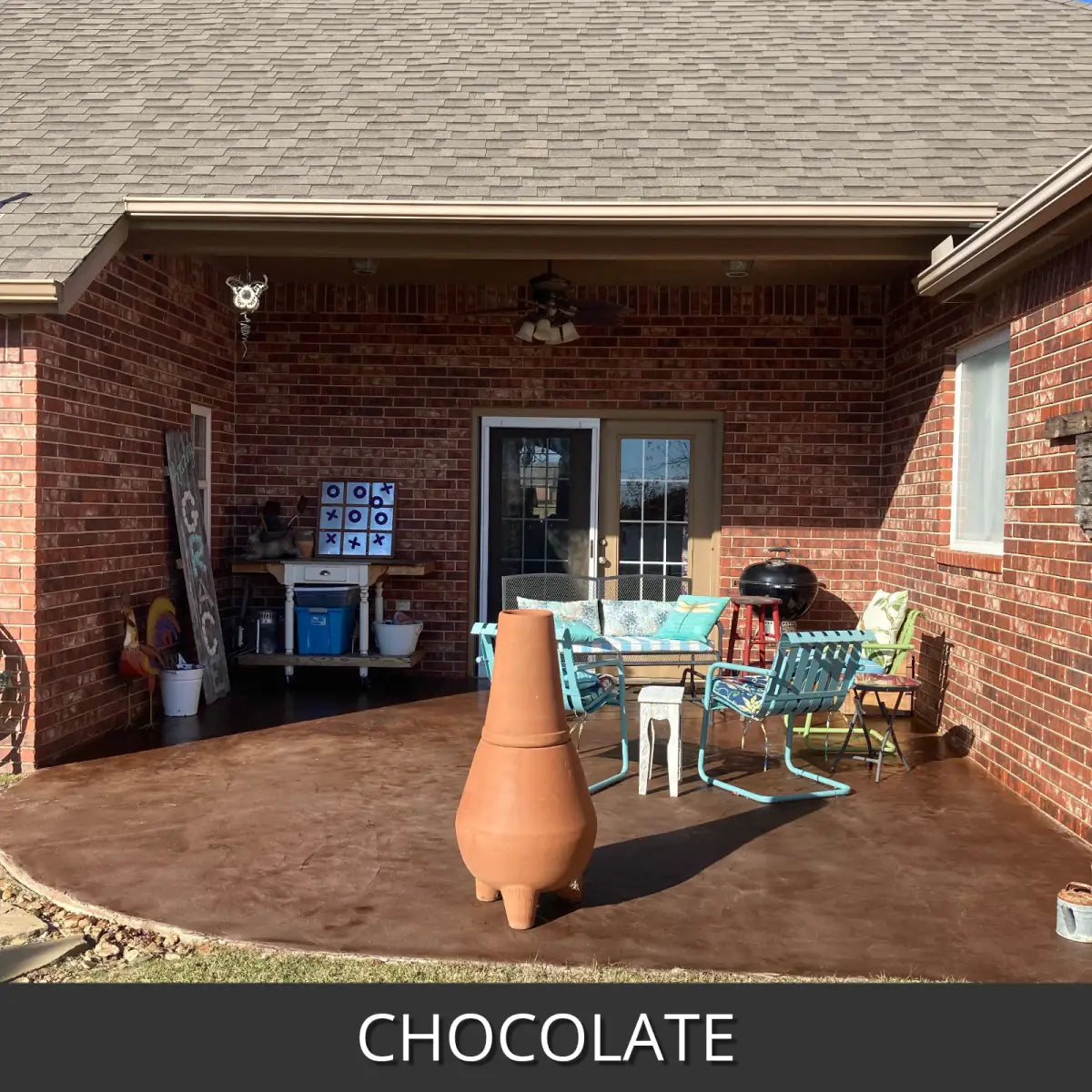 Sealed concrete patio at a brick house with outdoor furniture, EasyTint™ Tinted Concrete Sealer in 507 Chocolate