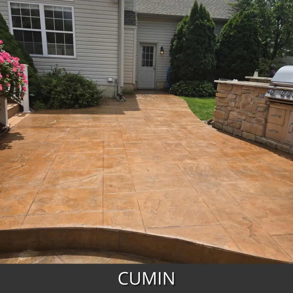 Stamped concrete patio with a curved border at an outdoor kitchen, EasyTint™ Tinted Concrete Sealer in 510 Cumin