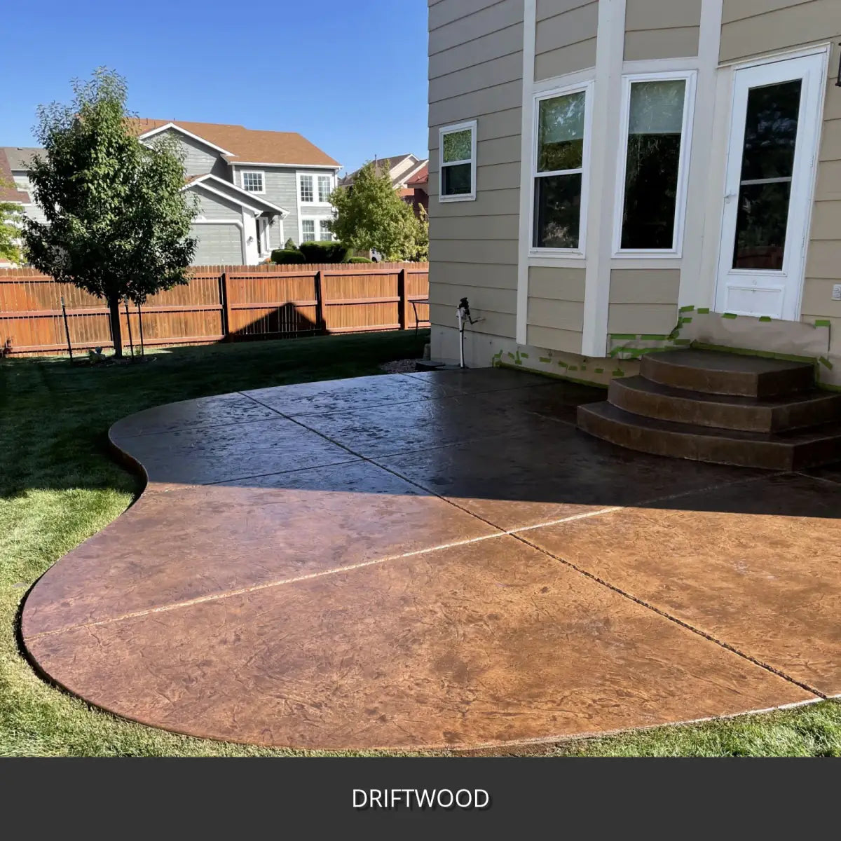 Stamped concrete patio with a curved contrasting border, EasyTint™ Tinted Concrete Sealer in 511 Driftwood