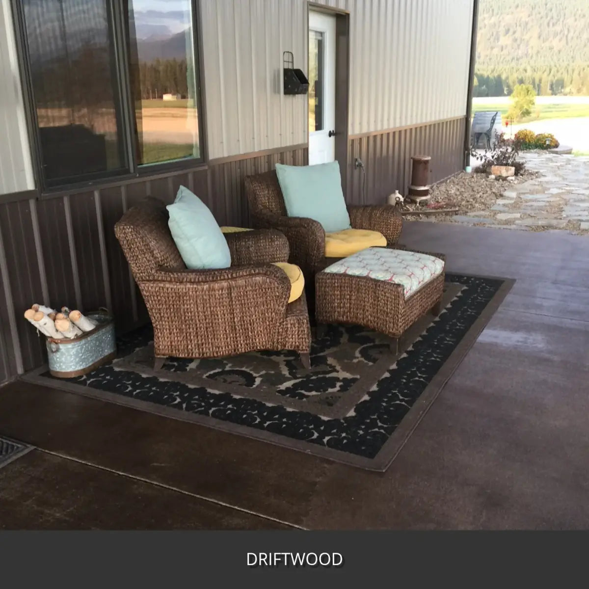 Stamped concrete patio with wicker chairs and a rug at a metal building, EasyTint™ Tinted Concrete Sealer in 511 Driftwood