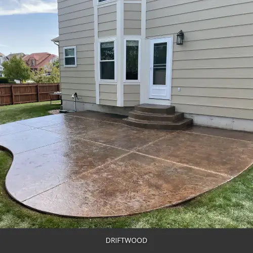 Stamped concrete patio with a curved edge at a bay window, EasyTint™ Tinted Concrete Sealer in 511 Driftwood