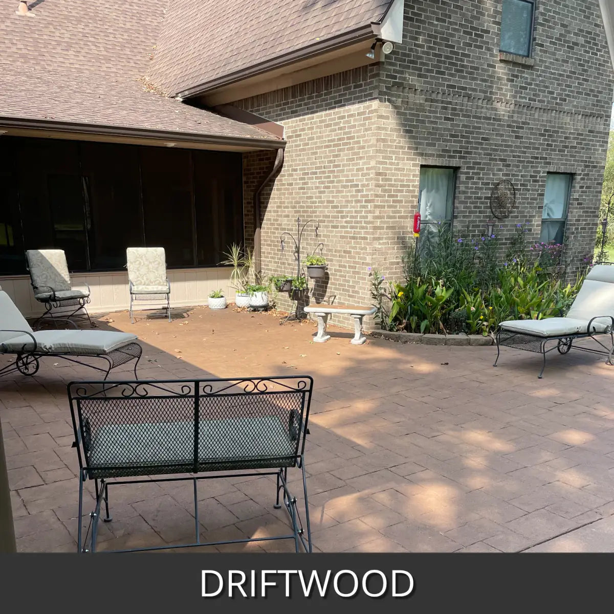 Sealed concrete patio beside a brick house with lounge chairs, EasyTint™ Tinted Concrete Sealer in 511 Driftwood