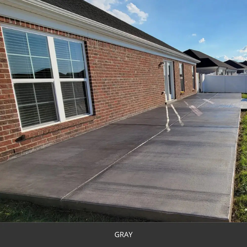 Sealed concrete patio slab beside a brick house, EasyTint™ Tinted Concrete Sealer in 515 Gray