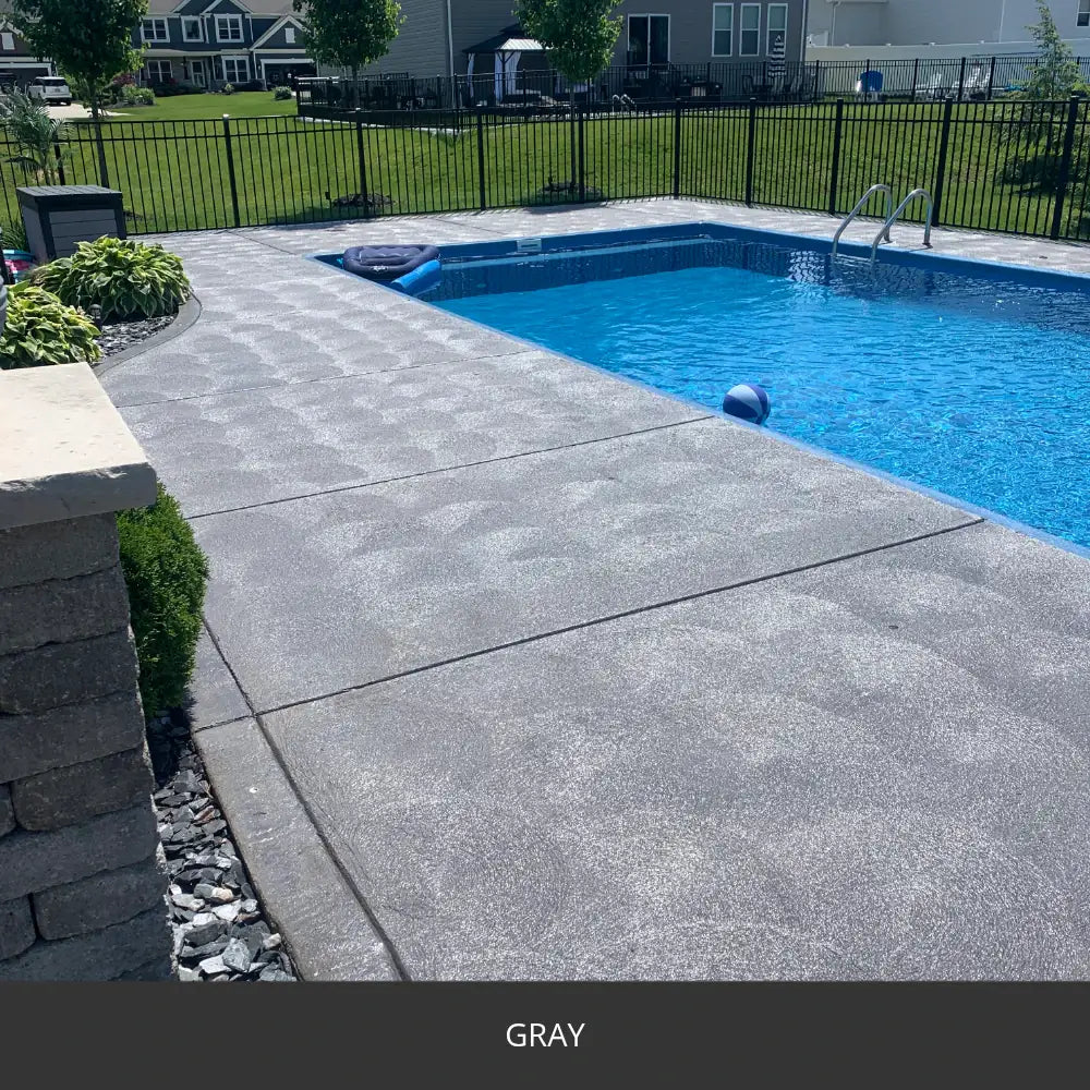 Sealed concrete pool deck along a rectangular pool, EasyTint™ Tinted Concrete Sealer in 515 Gray