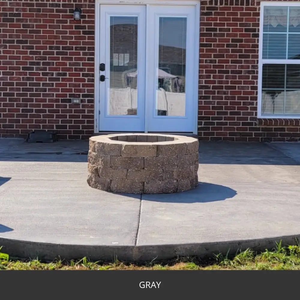 Sealed concrete patio with a stone fire pit at a brick house, EasyTint™ Tinted Concrete Sealer in 515 Gray