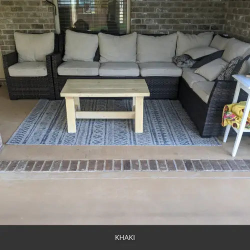 Sealed concrete patio under a covered porch with a sectional, EasyTint™ Tinted Concrete Sealer in 516 Khaki