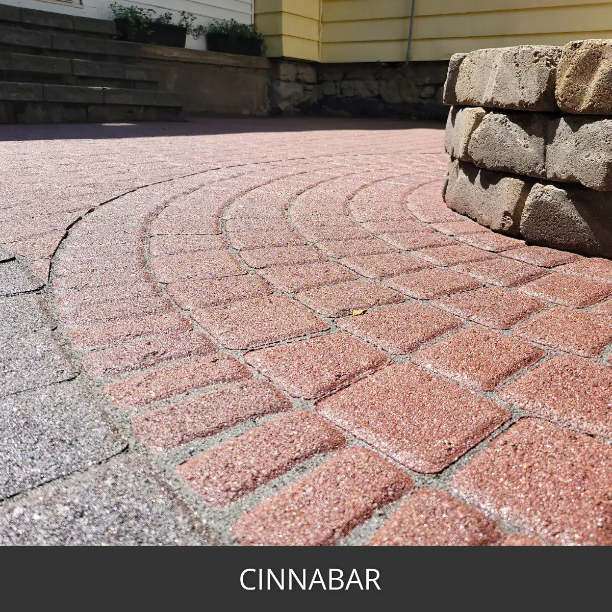 Stained paver patio in a circular pattern beside a block wall, Portico™ Paver Stain in 708 Cinnabar